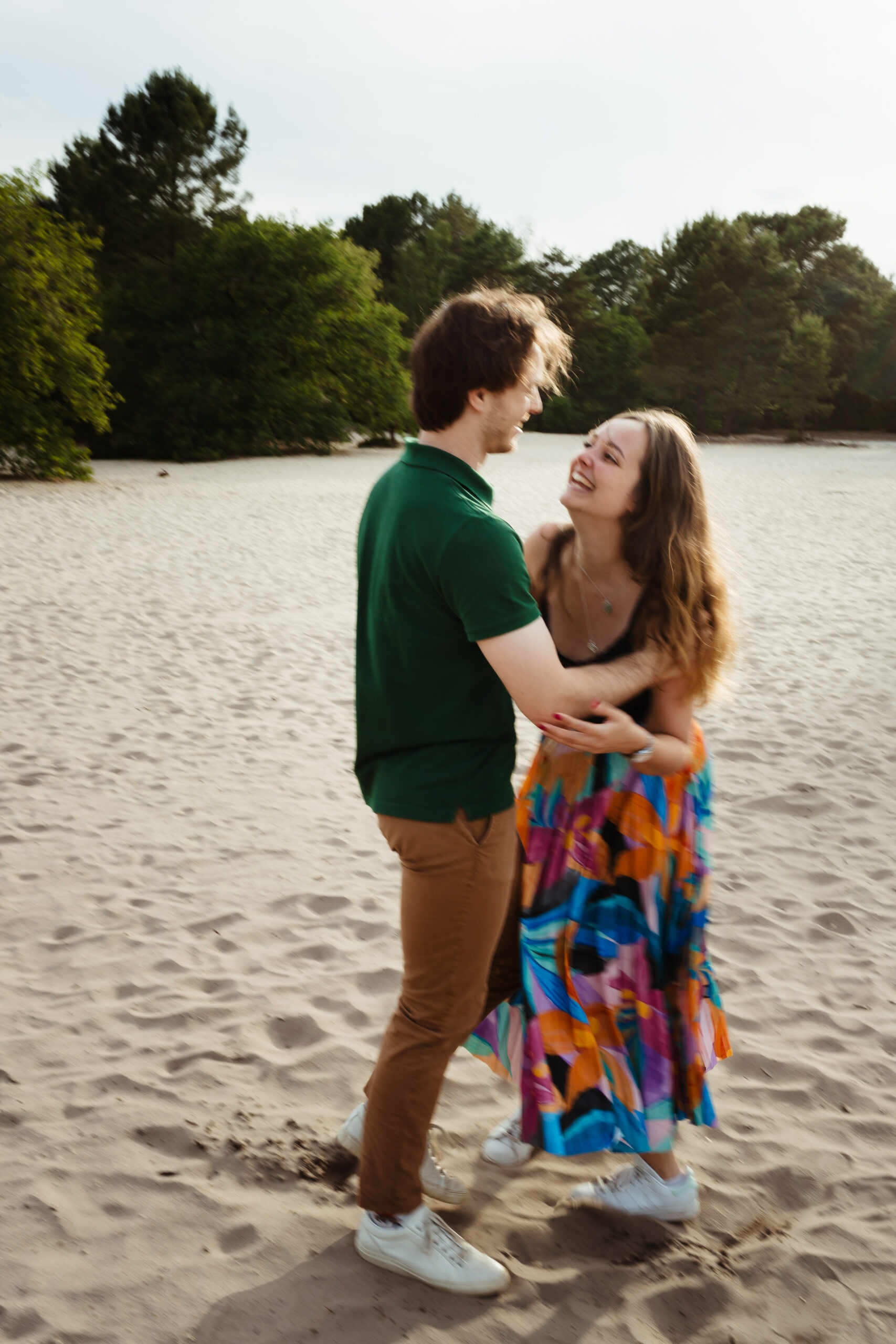 Couple jouant ensemble sur le sable de la forêt de Fontainebleau